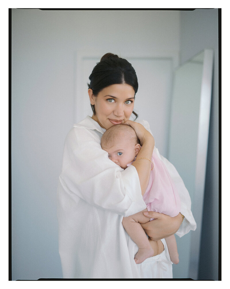 Mother and daughter looking at the camera for a newborn at-home shoot in Vancouver