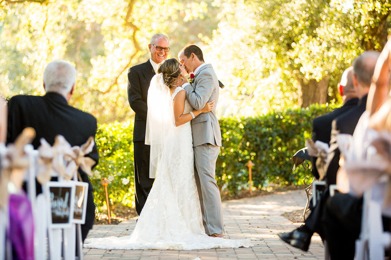 bride and groom first kiss at ceremony