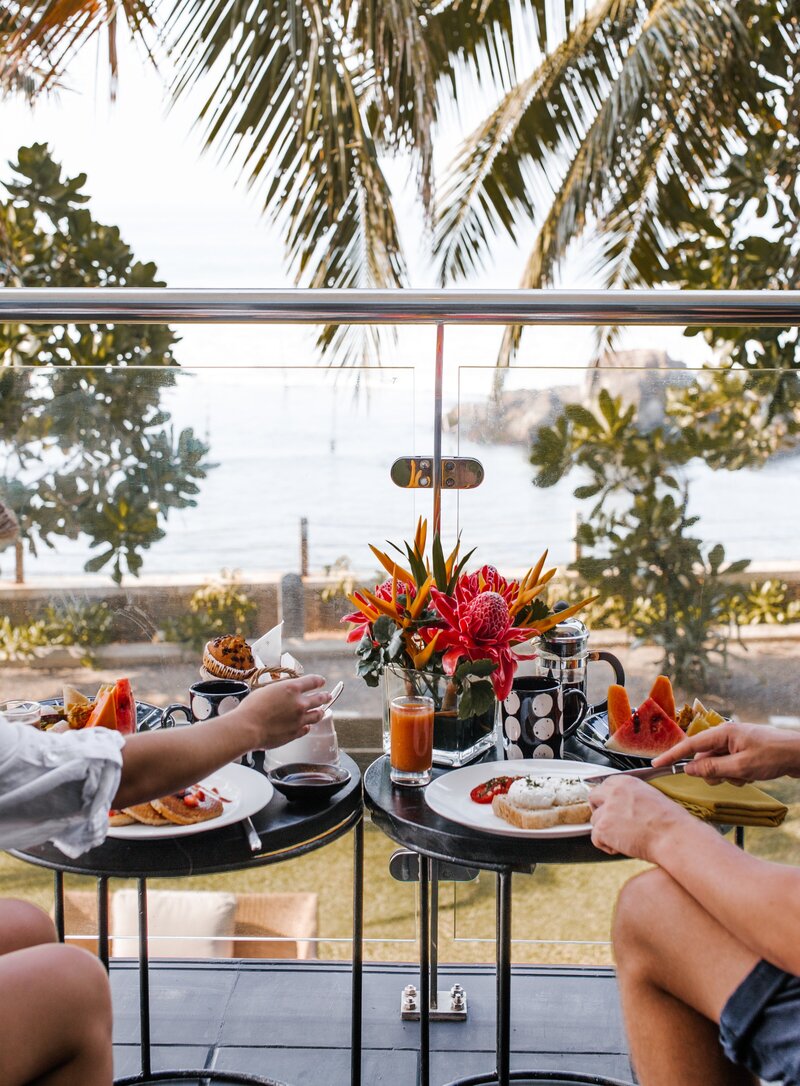 Couple having their breakfast in their beach front room