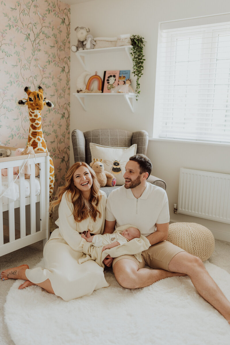 couple holding newborn baby at home