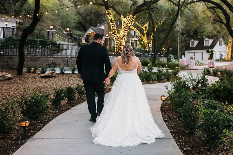 Bride and groom walking through the grounds of the Oaks at Duncan Lane, San Diego wedding venue