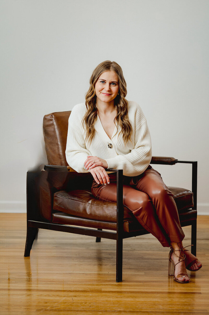 Business woman sitting on a large armchair