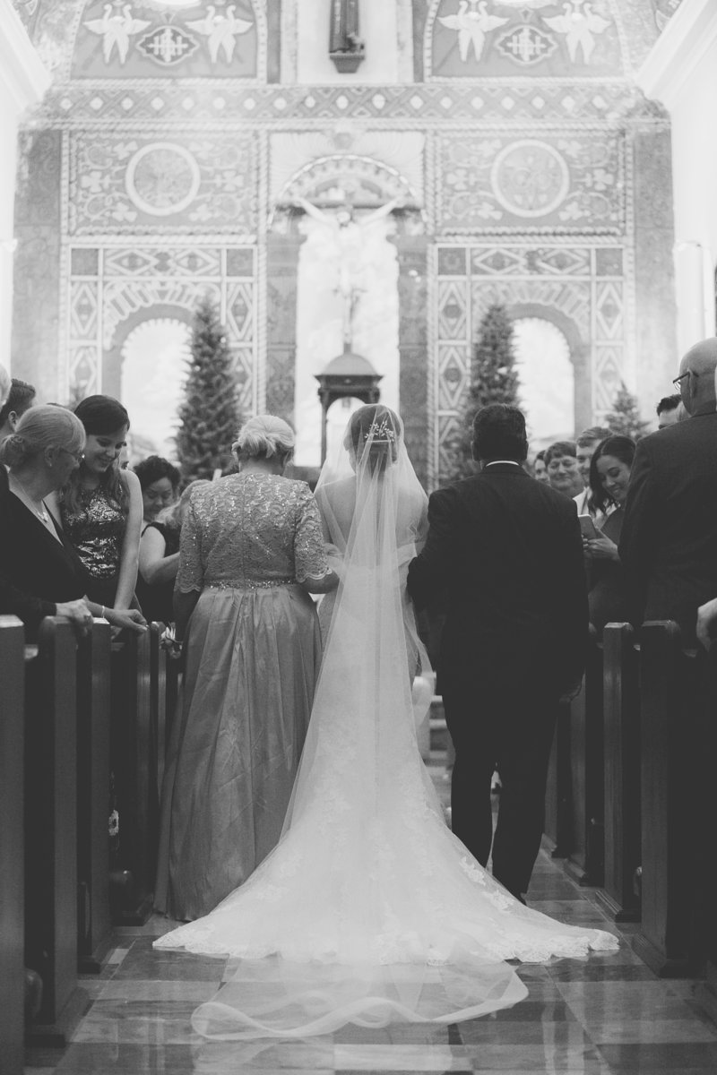 Bride walks in Parroquia San Francisco de Asis