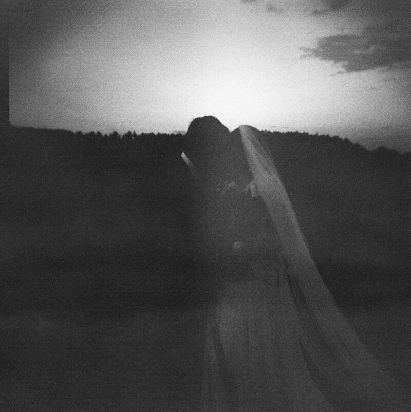 Bride and Groom embracing after sunset