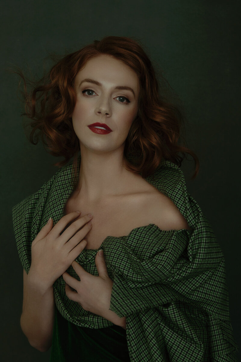 A red haired woman wearing green in a fine art portrait