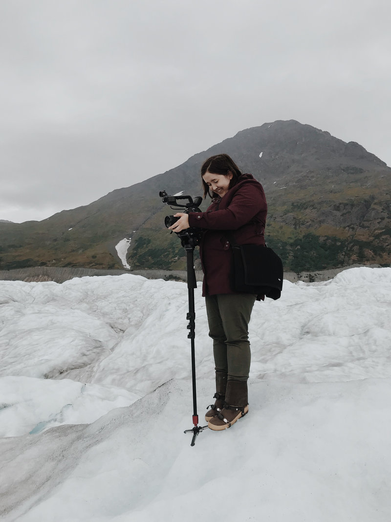 lauren roberts films with video camera on glacier