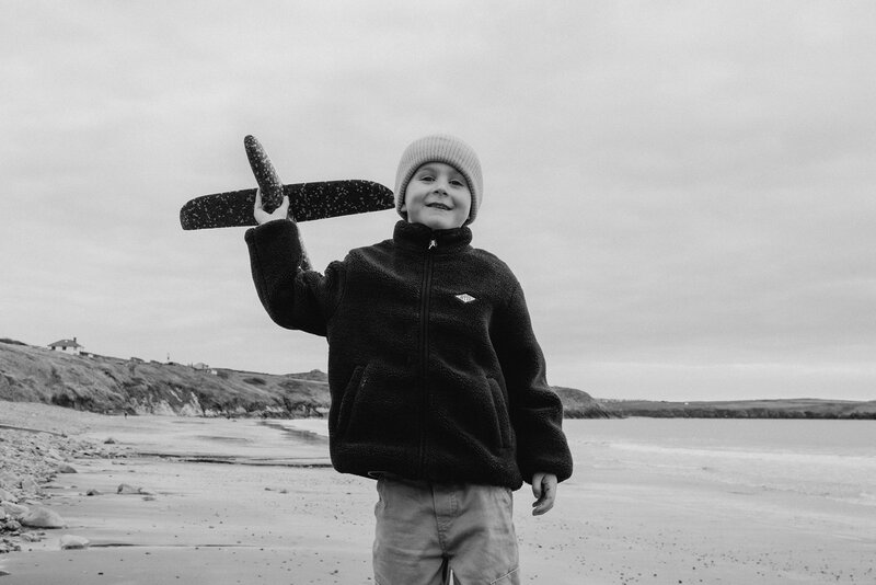 A candid family photography session in Wales capturing natural outdoor moments.