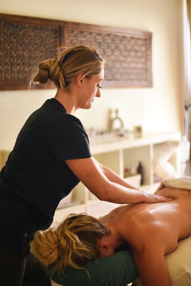 Registered Massage Therapist Noelle Rivet performing a signature massage