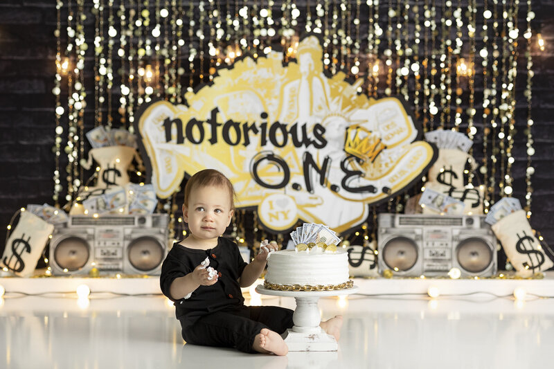 1 year old posing for a cake smash session with starry backdrop