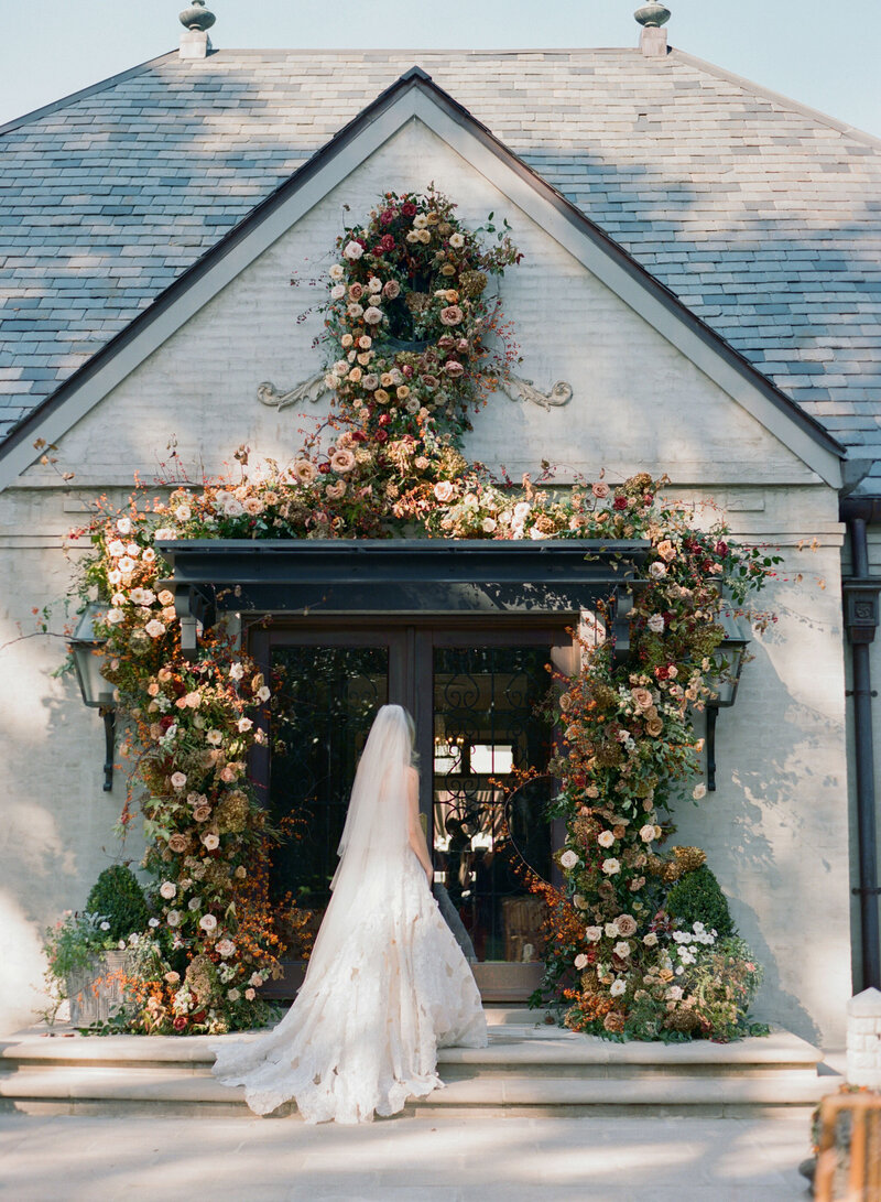 Beautiful autumnal bridal bouquet composed of roses, ranunculus, delphinium, clematis, lisianthus, and fall foliage floral hues of burnt orange, mauve, dusty rose, taupe, and lavender. Design by Rosemary and Finch in Nashville, TN.