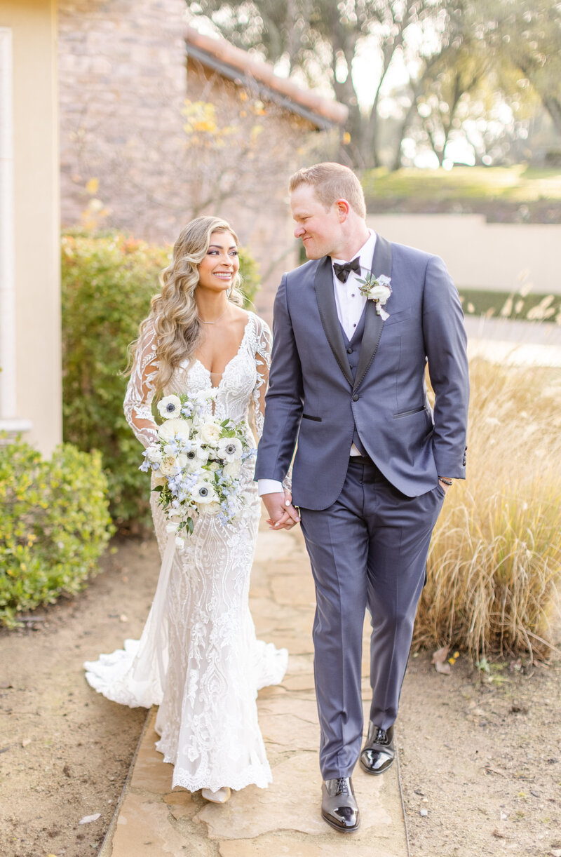 bride and groom looking at each other smiling