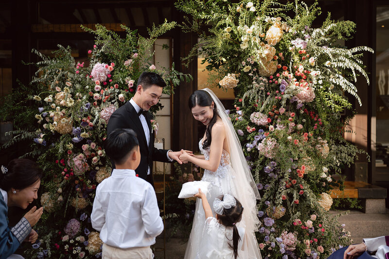 groom kisses bride on the head in the Secret Forest in Jeju Island