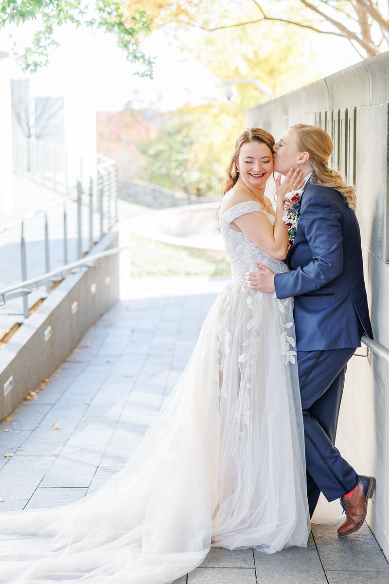 two brides smiling during wedding portraits at the nelson atkins
