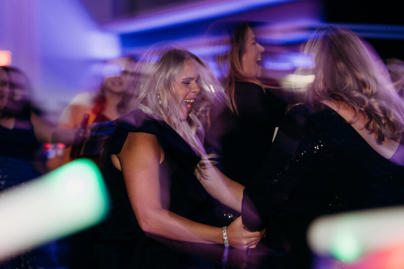 group of female employees joyfully dance to club music