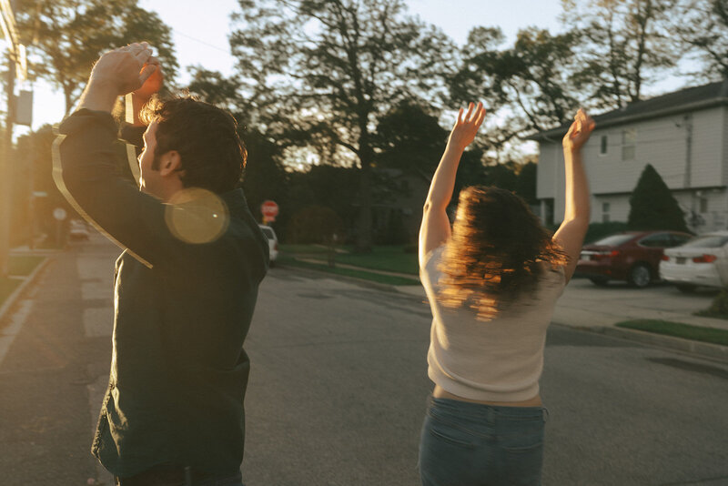 couple dancing in the street during at home engagement photos, captured by Elsie Goodman, an NYC engagement and couples photographer
