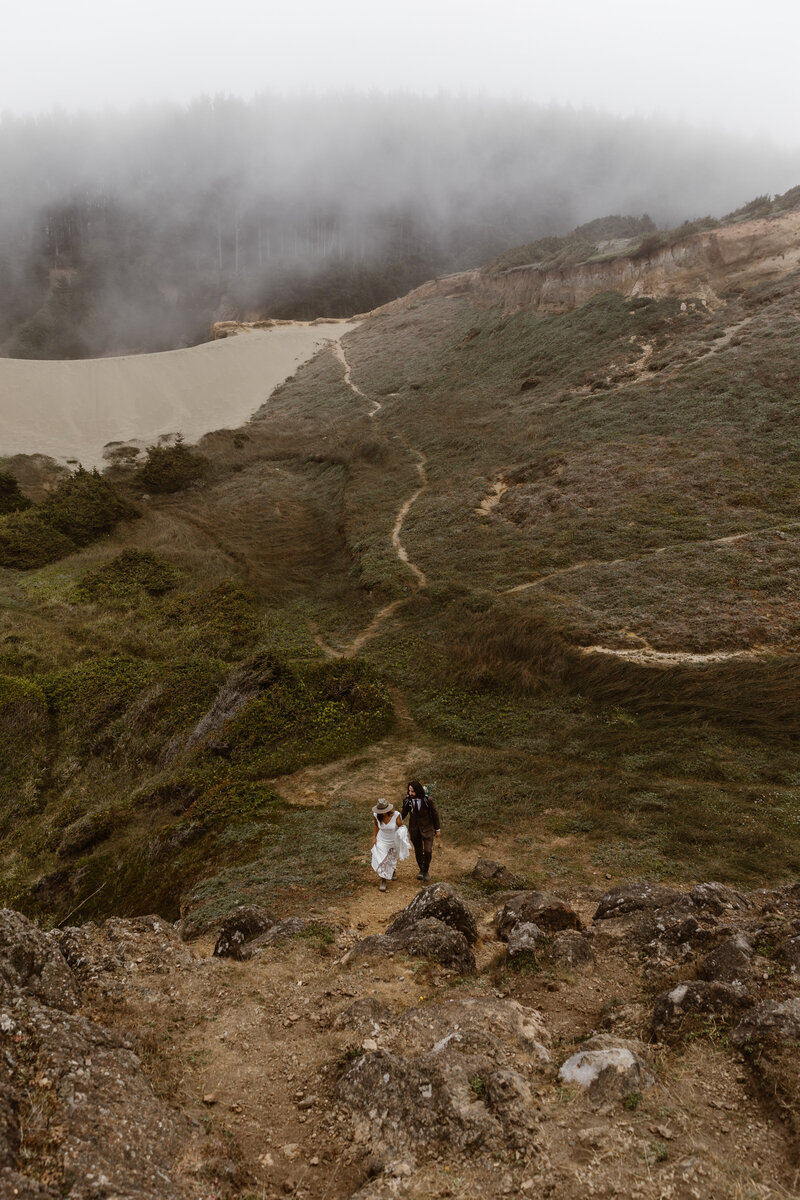 bride and groom on hillside