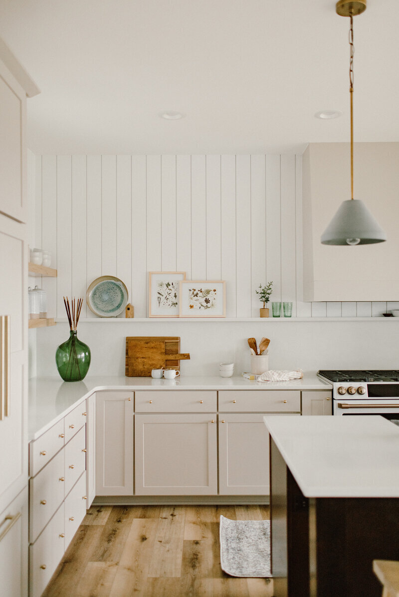 Transitional modern custom remodel kitchen in Ames, Iowa with white wood panneling and green accents 