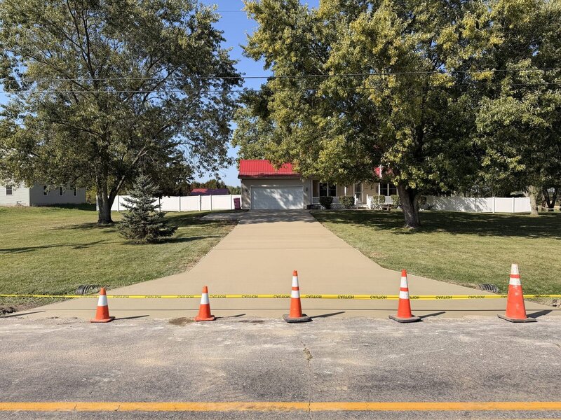 After: new full-width concrete driveway at the same Goshen, IN home