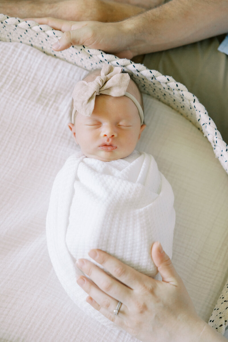 Newborn baby swaddled in neutral blanket during Fresno lifestyle photography session