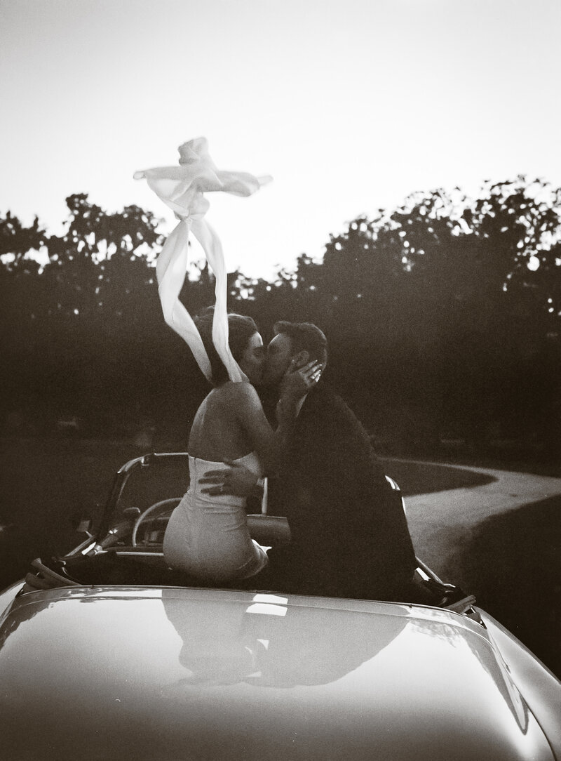 bride and groom running through the grass