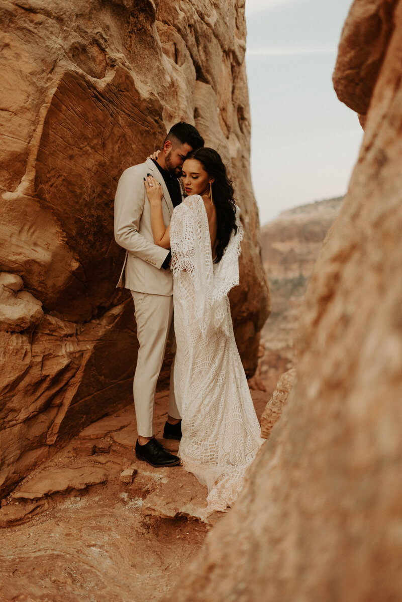 bride and groom walking on mountaintop