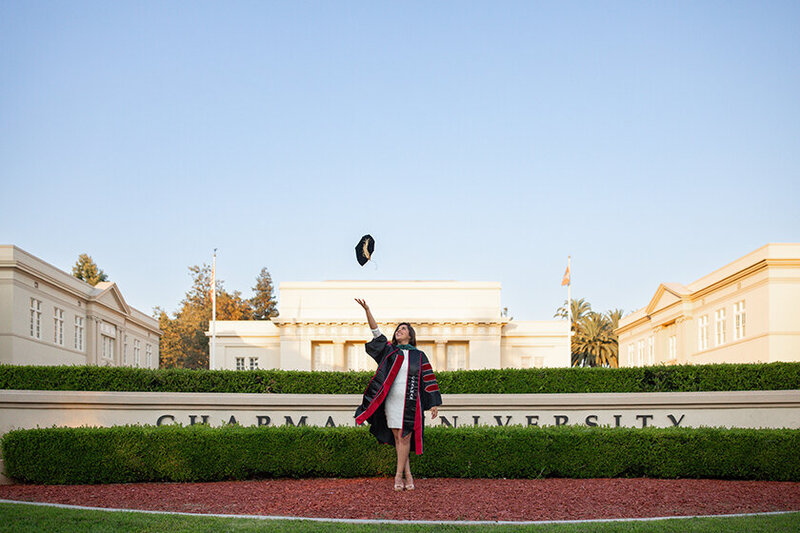 Grad tossing cap in air on campus at Chapman University