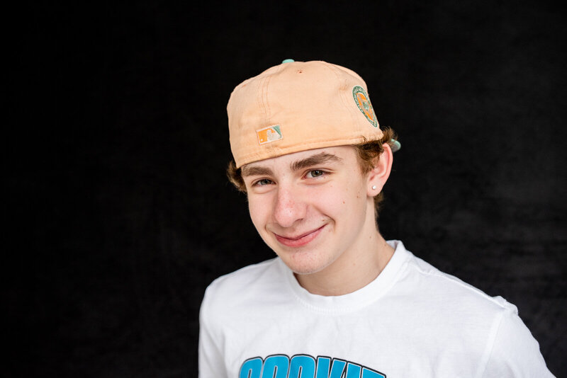 Teenage boy wearing his favorite hat backwards in a casual t-shirt for personality portraits