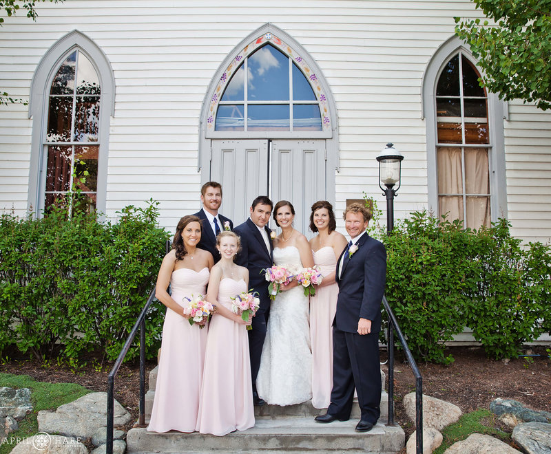 Wedding party formal portrait on the front steps of St. Mary's Catholic Church at a summer wedding in Breckenridge Colorado