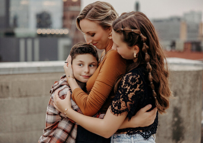 Mother playing ring around the rosie with her four children.