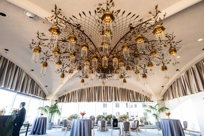 Fairmont San Francisco terrace reception with elaborate chandelier and city views - wedding photographer