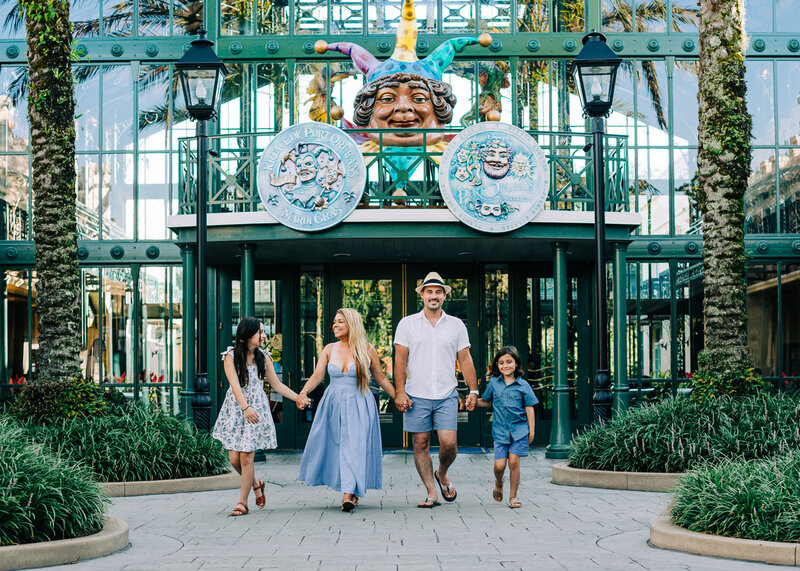 family at Disney's French Quarter resort, walking and holding hands, laughing and smiling