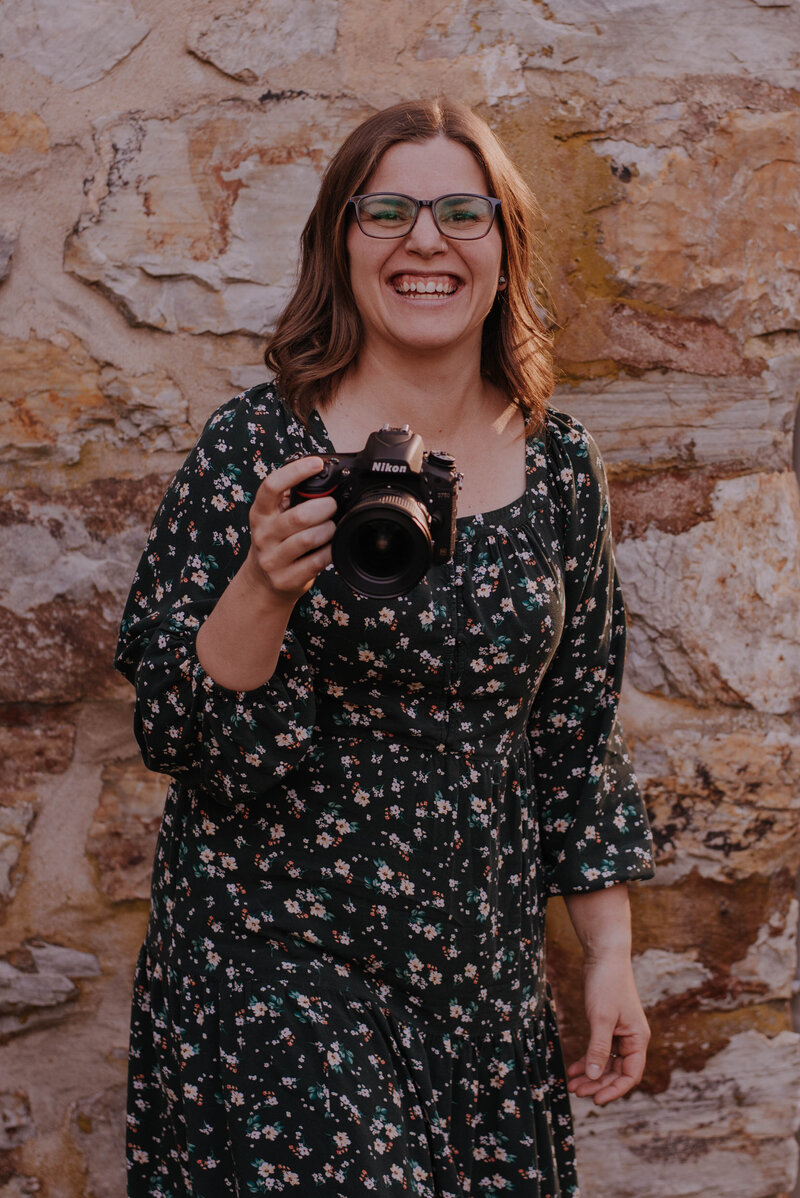 Northern Virginia wedding photographer Danielle Towle holding camera