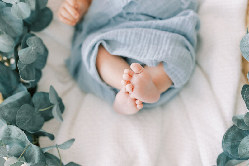 newborn baby feet with blue wrap around legs