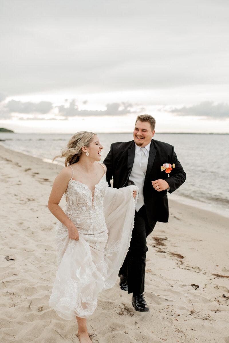 Bride and Groom running on the beach