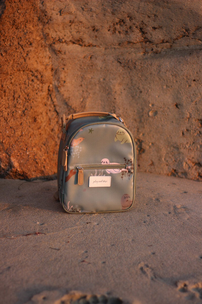Warm toned beach product photography of mini kids backpack