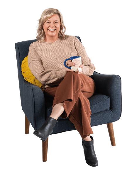 Lori Lubbers in chair drinking tea