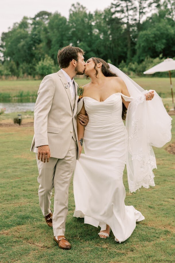 Bride in white wedding dress blowing in wind and floral bouquet