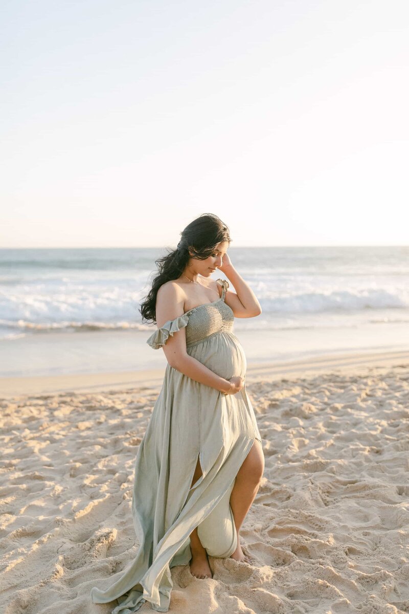 Orange County Maternity Photographer - woman in green dress at sunset on the beach