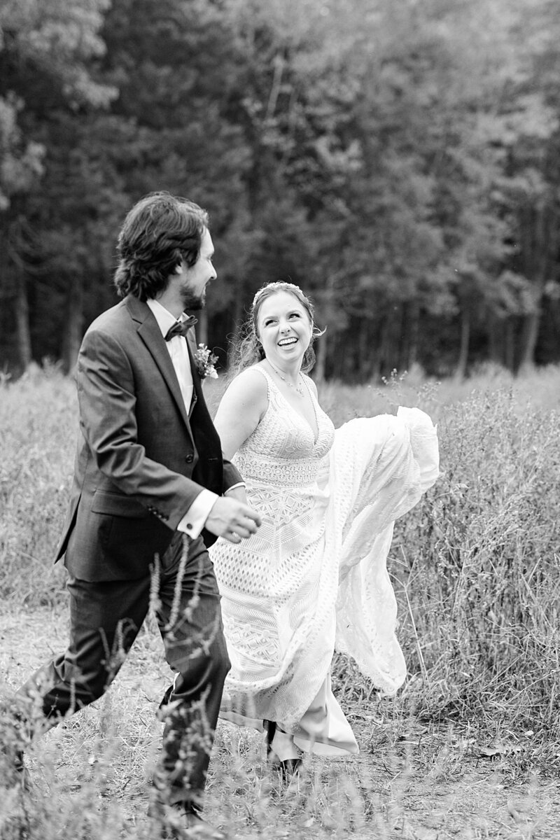 Bride and groom running in a field at Avonlea Farms in Richmond, Virginia.