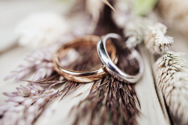 Two wedding rings, one gold, one silver.
