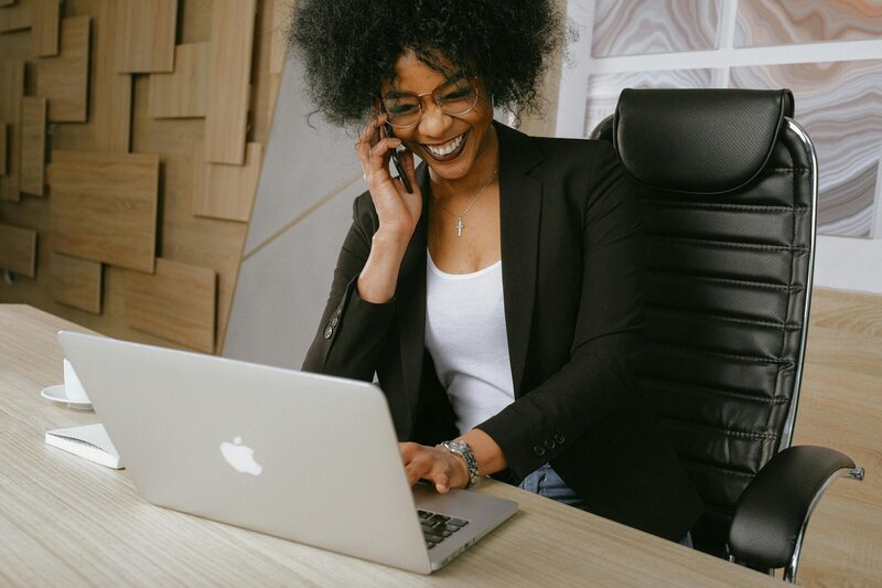 Female in her office answering a marketing client call
