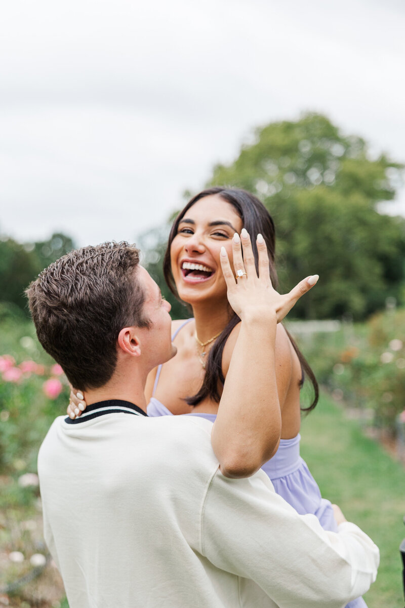 Ariana laughing and showing her ring right after a surprise proposal