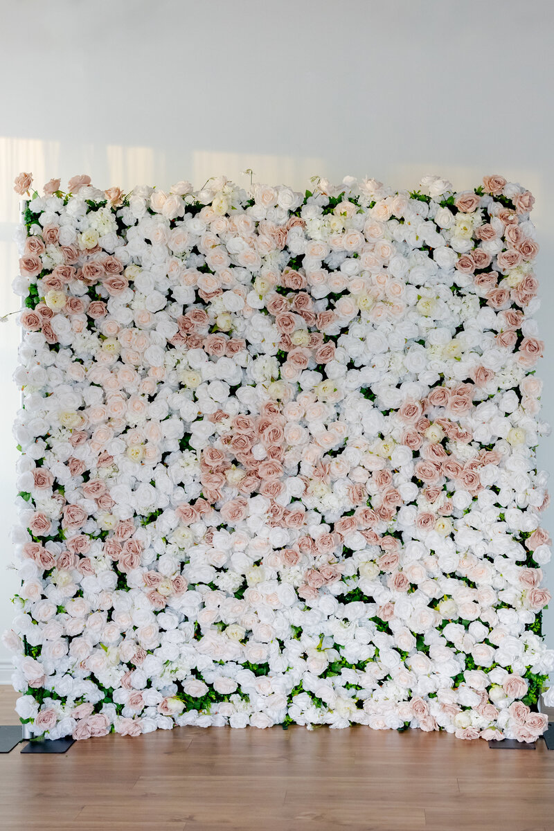 Floral wall with dark and light pink roses.