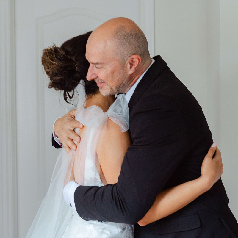 Ottawa wedding photography showing a bride and her father hugging after he sees her for the first time