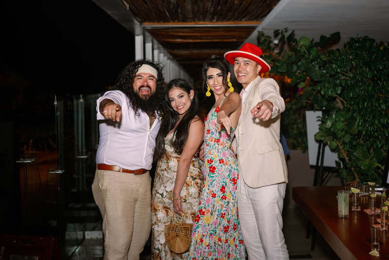 A group of guests posing for a picture during a wedding in Dreams Vista Cancun, Mexico.