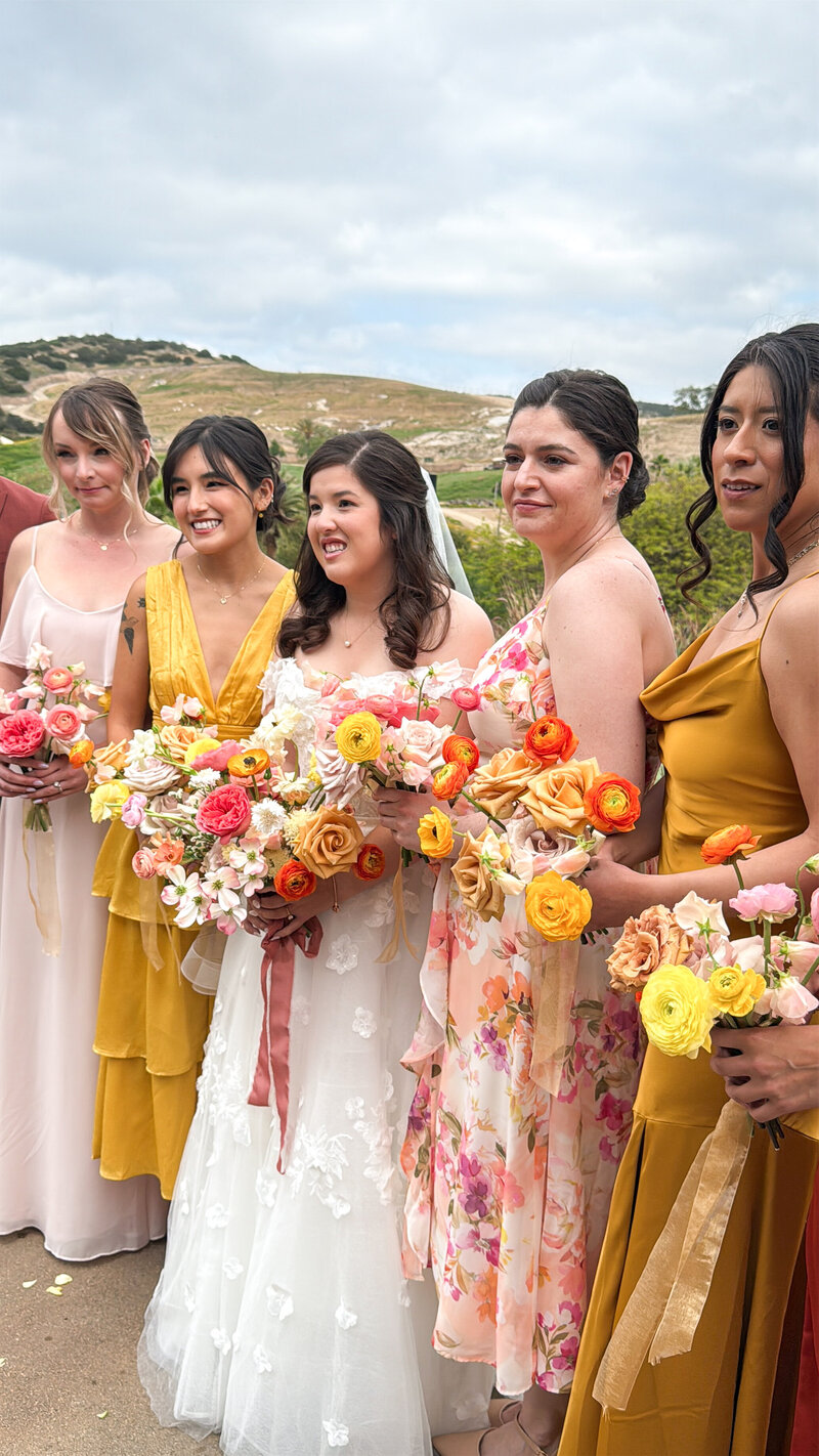 Bride with her bridesmaids in yellow, champagne, and floral patterns taking their portraits at San Diego Safari Park San Diego Zoo Safari Park.