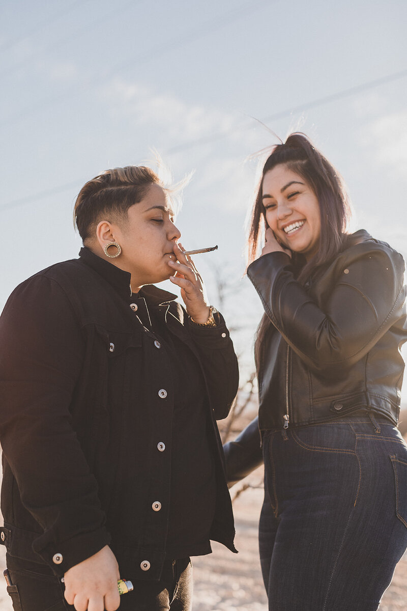 LGBTQIA+ couple does a little gardening in las vegas desert during engagement photo session