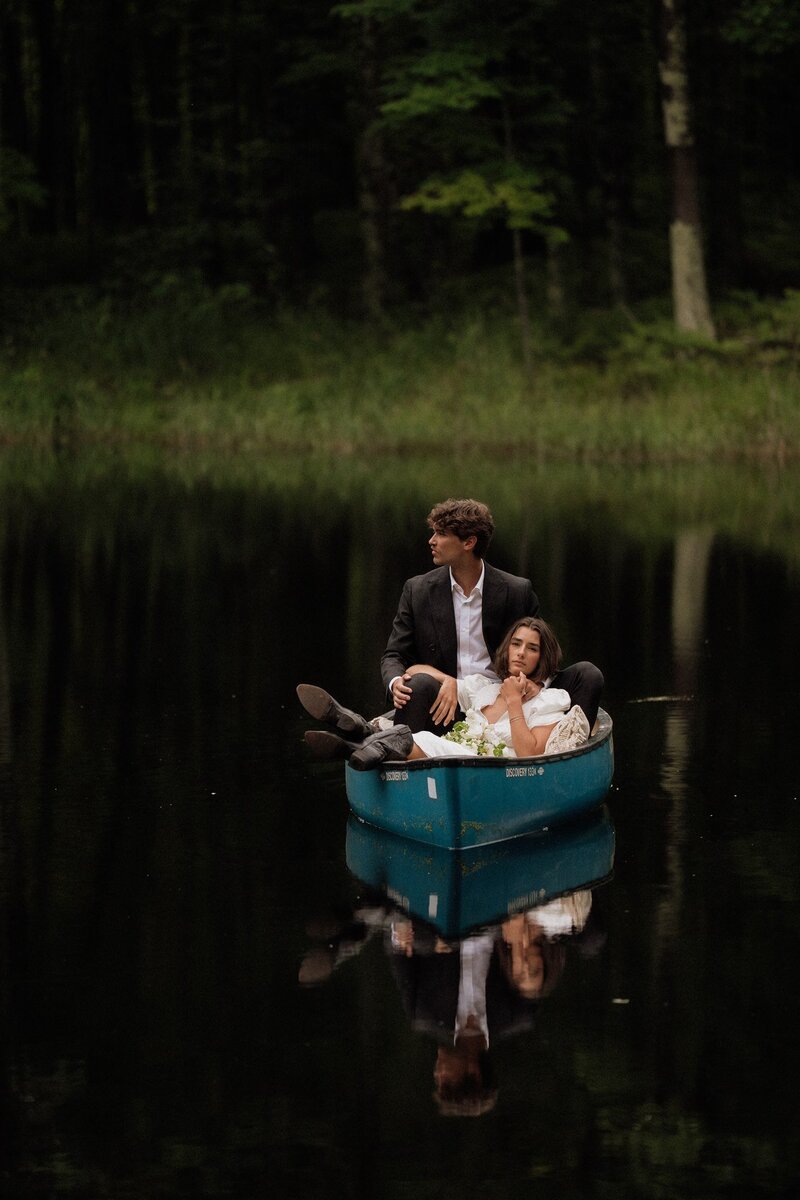 bride and groom holding flowers in black and white 