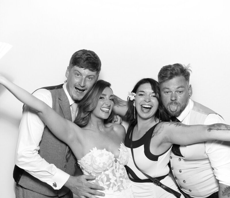 B&W image of guests posing for a Wedding reception at Ivy Lodge in Cirencester, by Cripps Barn venues in the Cotswolds
