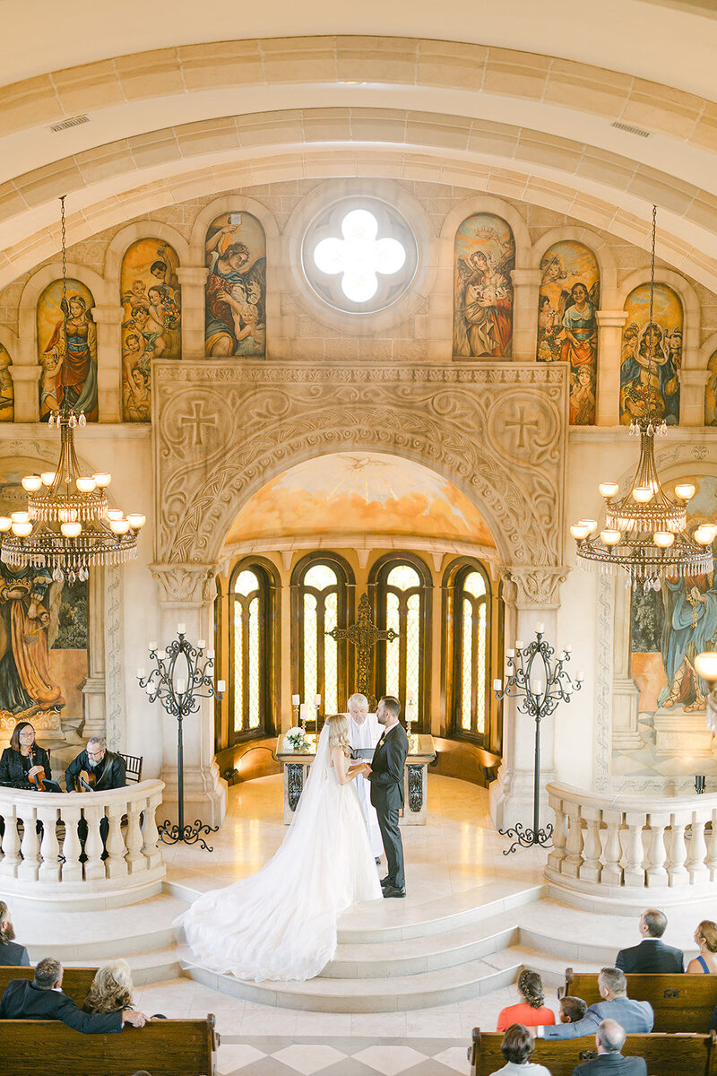 Bride and groom holding hands in cathedral captured by Nashville wedding photographer